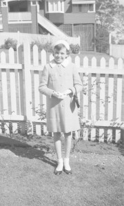 Illustrating Jill's point, dressed for town or church with gloves, hat and patent leather shoes.