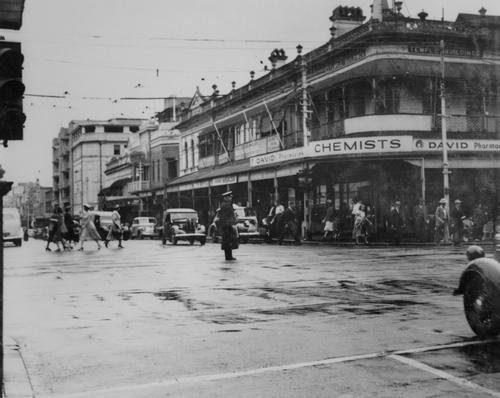 Unidentified (1950). Police officer directing traffic on George Street, Brisbane, 1950. John Oxley Library, State Library of Queensland